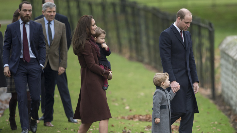 Kate Middleton and Prince William walking to church with Princess Charlotte and Prince George, followed by James and Michael Middleton