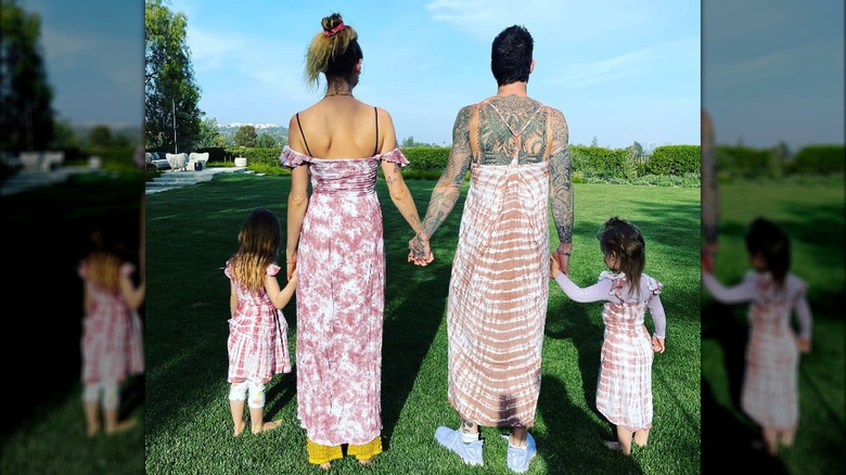 Behati Prinsloo and Adam Levine pose with their daughters in matching dresses.