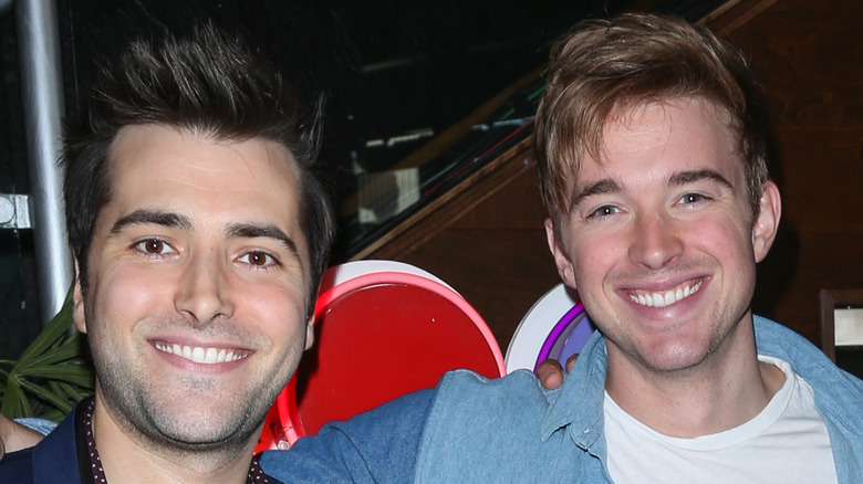 Freddie Smith and Chandler Massey smile for the camera at an event.