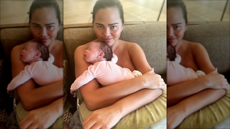 Chrissy Teigen holding baby Esti