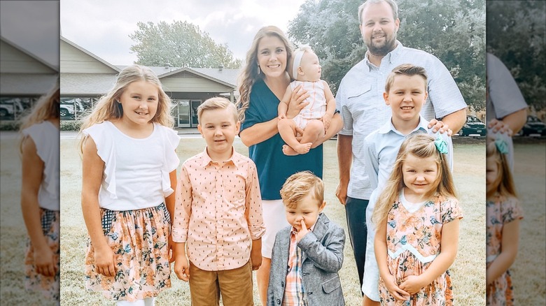 Anna Duggar and Josh Duggar pose outdoors with their children