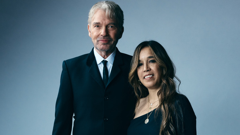 Billy Bob Thornton and Connie Angland posing in front a gray background