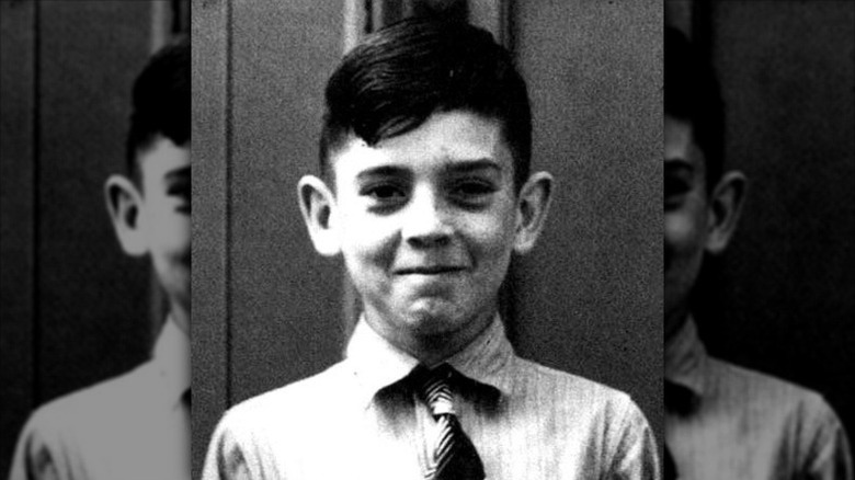 A 10-year-old Dan Rather smiles in a shirt and tie