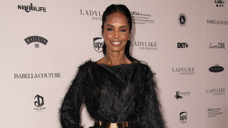 Kim Porter posing at a luncheon