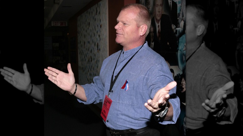 Mike Holmes with his arms outstretched