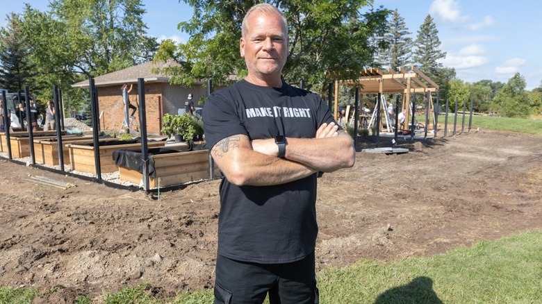 Mike Holmes standing arms crossed