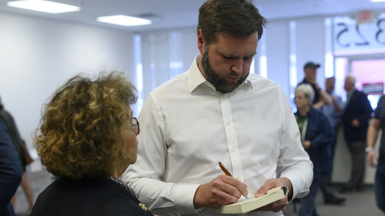 JD Vance signing a copy of his memoir, "Hillbilly Elegy."