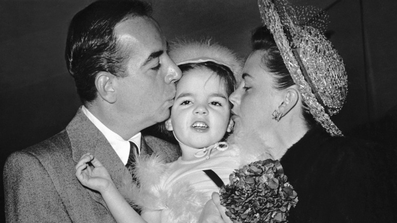 Vincente Minnelli and Judy Garland kiss young Liza on the cheeks