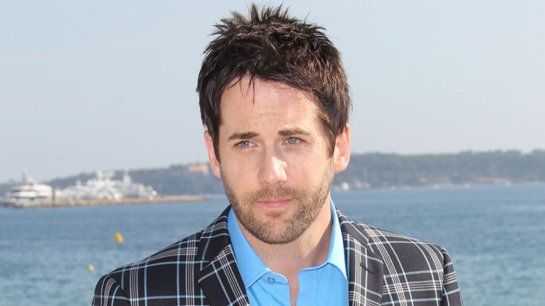 Niall Matter poses in a checked suit in Cannes