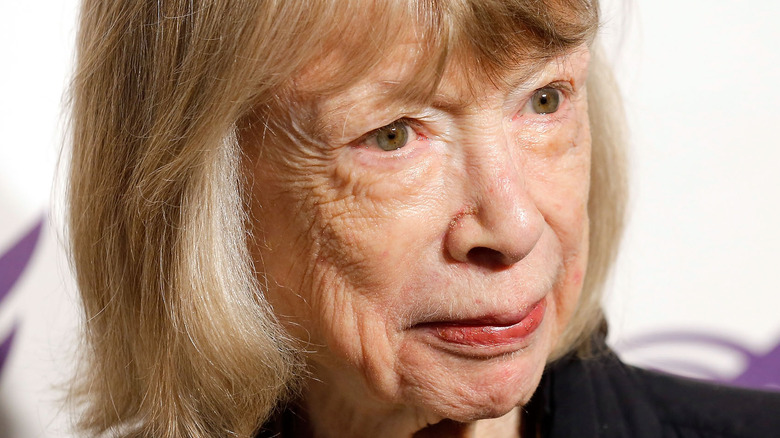 Joan Didion smiles at an event