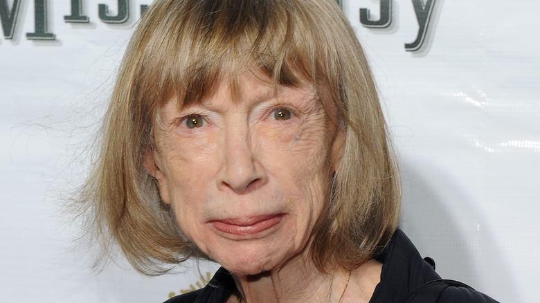 Joan Didion poses on the red carpet