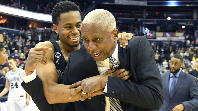 Basketball player hugging Louis Orr