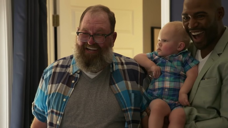 Tom Jackson smiling with his grandson