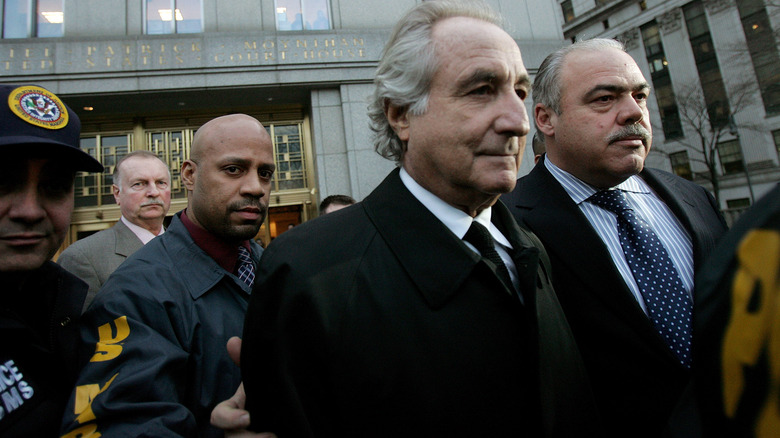 Bernie madoff being handcuffed by cop