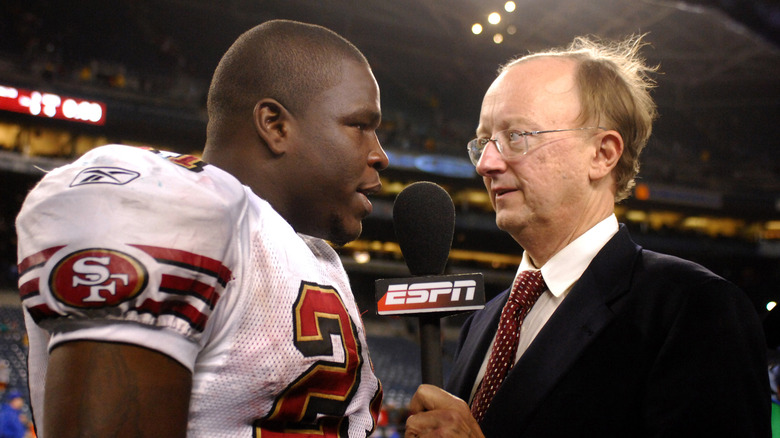 John Clayton interviewing player on the field