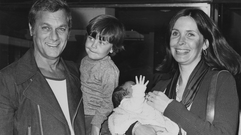 Tony Curtis holding Nicholas and Leslie Allen holding Benjamin.