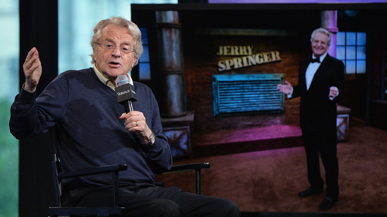 Jerry Springer holding a microphone