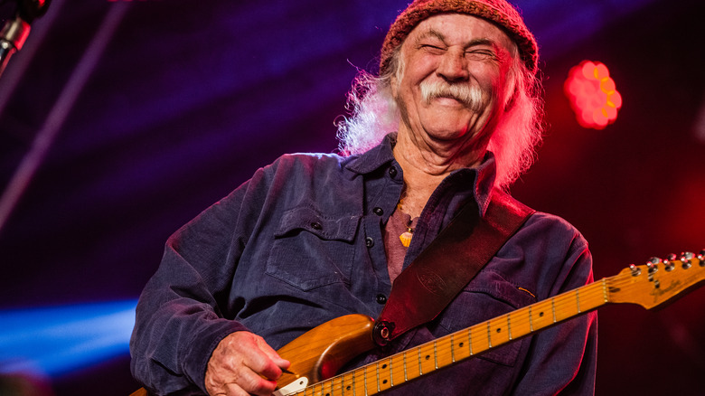 David Crosby smiling with guitar