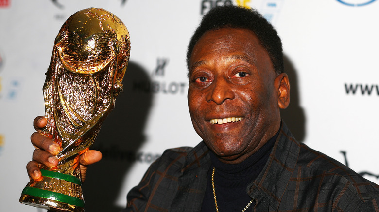 Pele holding up a World Cup trophy