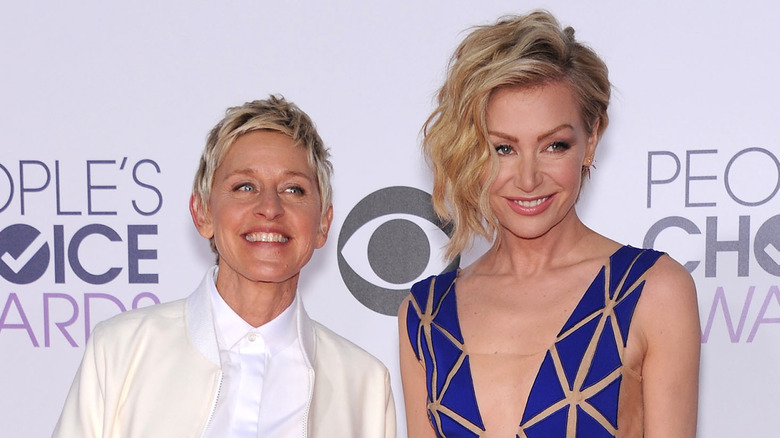 Ellen DeGeneres smiling with Portia De Rossi