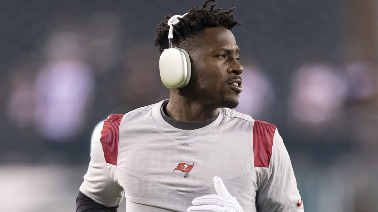 Antonio Brown wearing headphones while warming up for a Tampa game