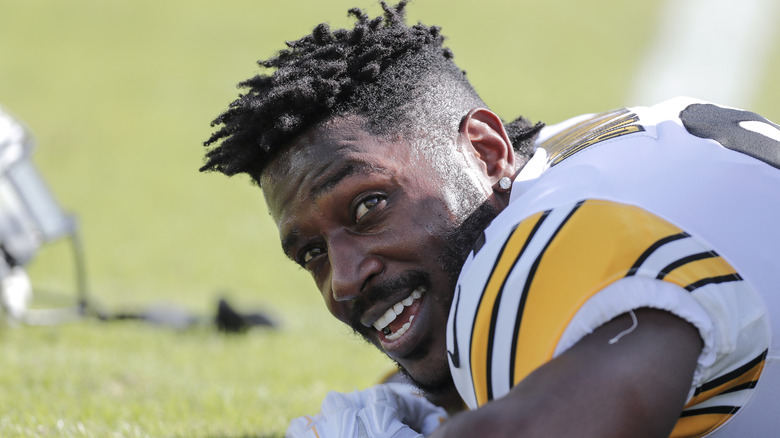 Antonio Brown lying down on the field in home jersey