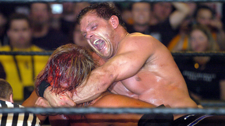 Chris Benoit keeps Triple H in a crossface