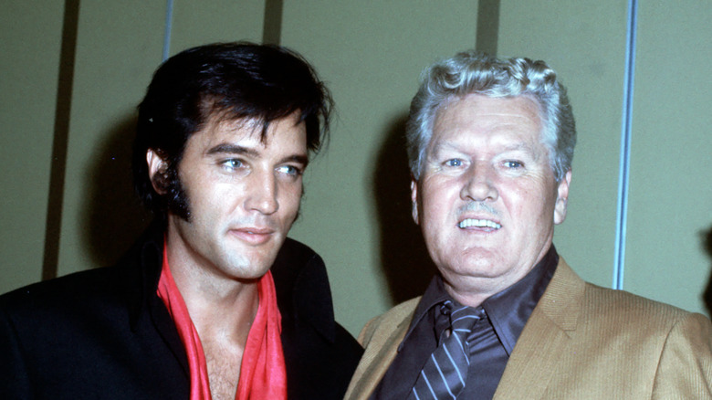 Elvis and Vernon Presley smiling