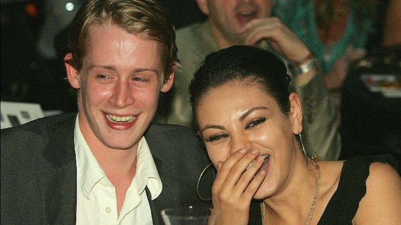  Macauley Culkin and Mila Kunis, both laughing