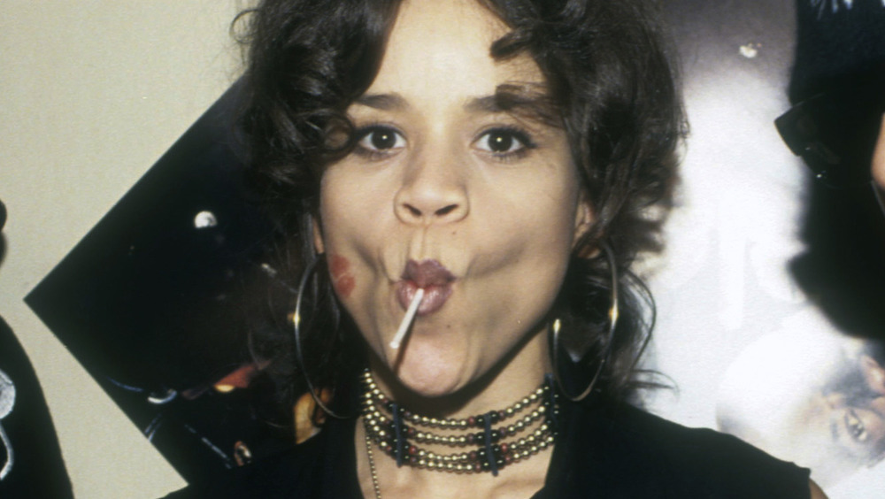 Rosie Perez pulling a funny face while sucking a lollipop