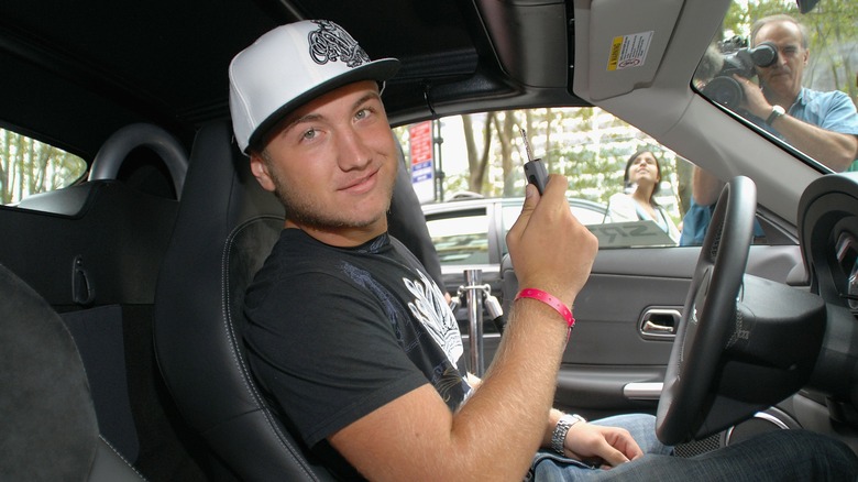 Nick Hogan poses behind the wheel