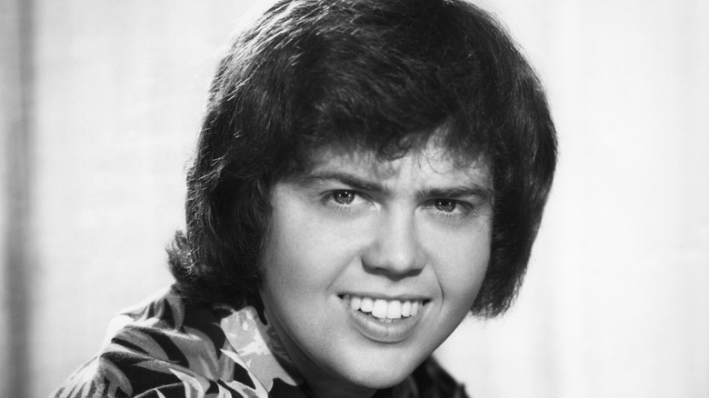 Merrill Osmond smiles black and white