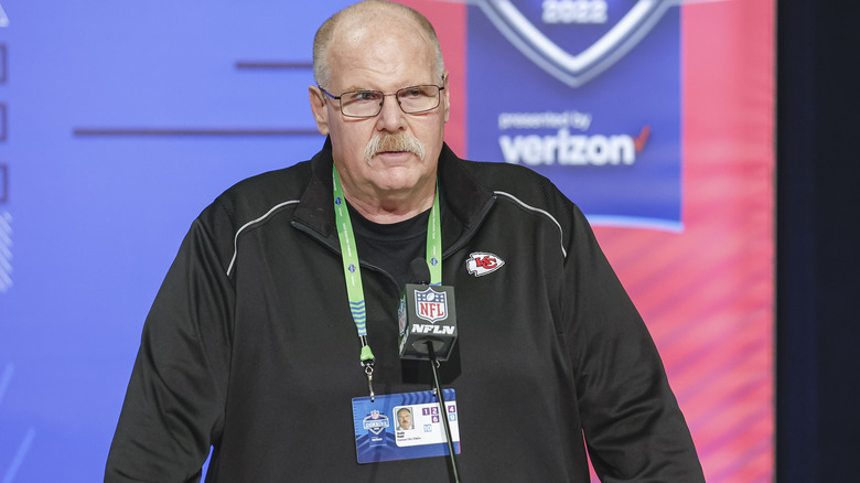 Andy Reid looking serious in front of microphone