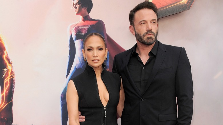 Jennifer Lopez and Ben Affleck wearing black and posing