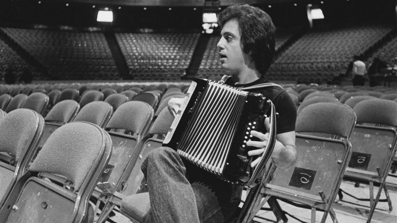 Billy Joel playing accordion in empty stadium