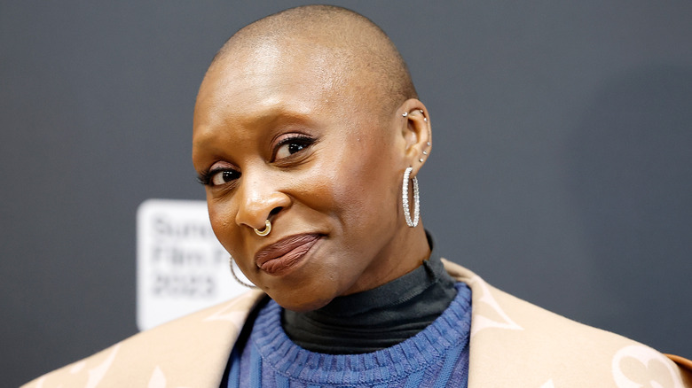 Cynthia Erivo wearing multiple silver earrings and posing at the Sundance Film Festival.