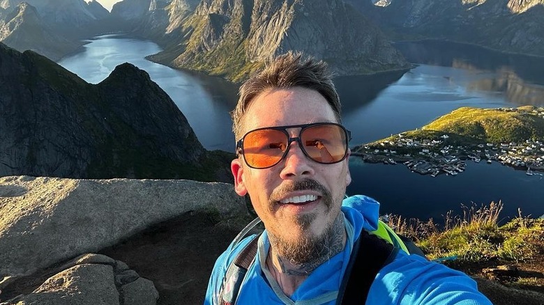 David Bromstad posing in front of a lake