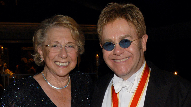 Elton John posing with his mother at an event