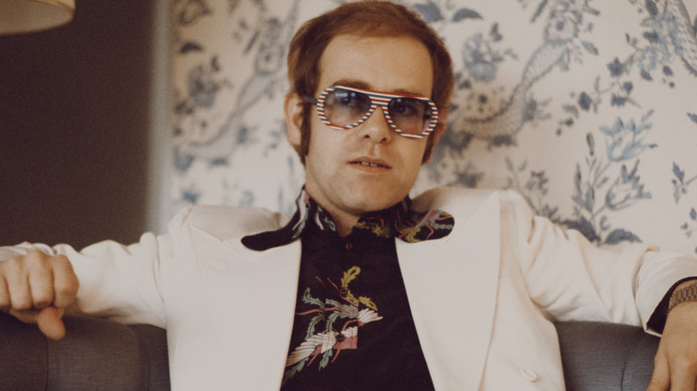 Elton John sitting on a couch