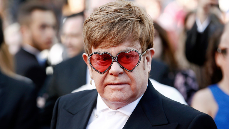 Elton John posing at an event