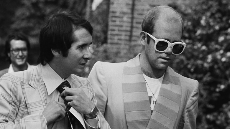 Elton John and John Reid walking