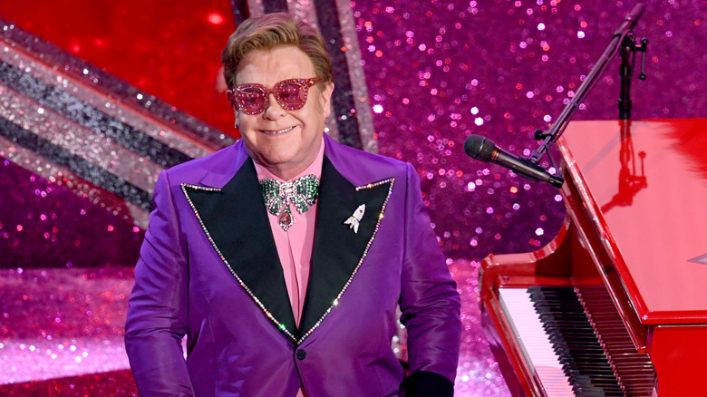 Elton John looking at the audience from his piano