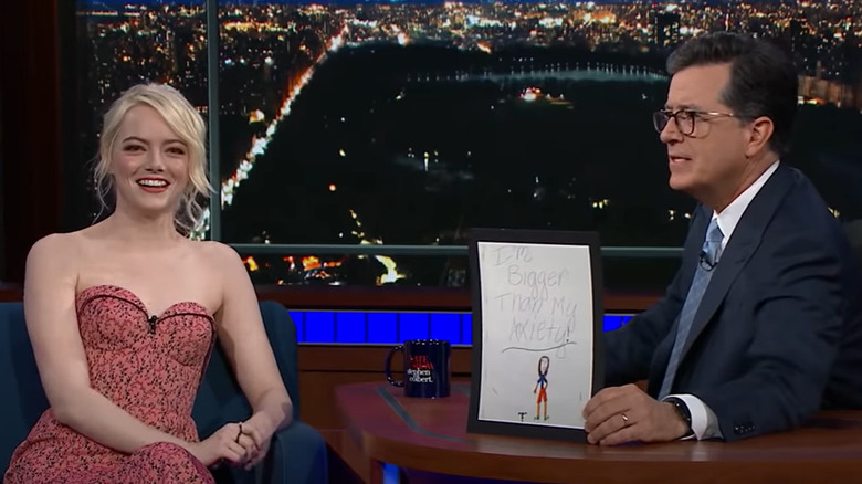 Emma Stone seated next to Stephen Colbert