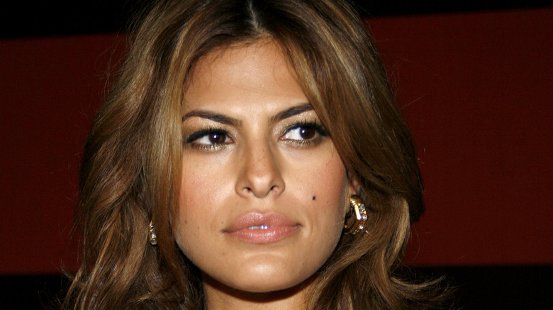 Eva Mendes wearing large gold hoop earrings and gazing off to the side