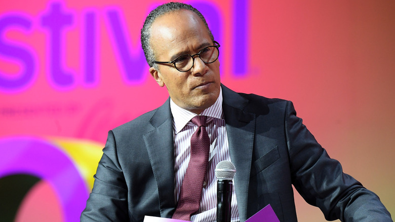 Lester Holt speaking on stage at the Essence Festival in 2018.