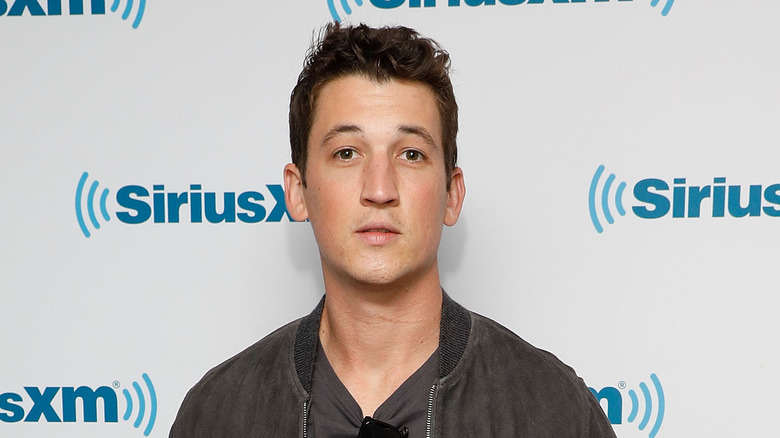 Miles Teller in brown jacket