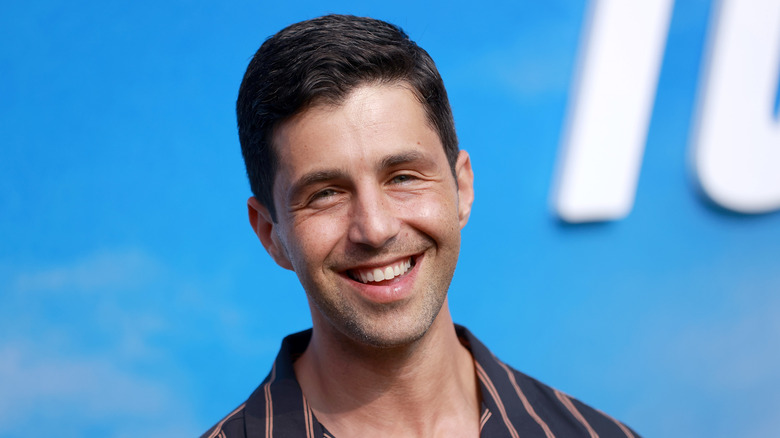 Josh Peck smiling while posing at an event