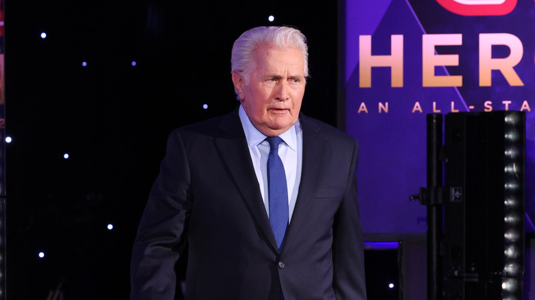 Martin Sheen stands in blue tie