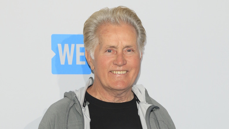 Martin Sheen smiling in gray sweatshirt