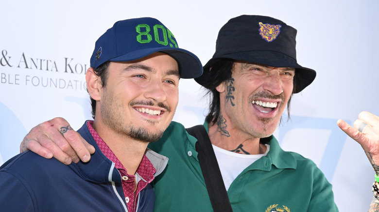 Brandon Thomas Lee and Tommy Lee pose at golfing event